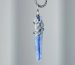 Natural blue kyanite pendant necklace with hand-soldered tin wire design, resembling ocean waves and glaciers.